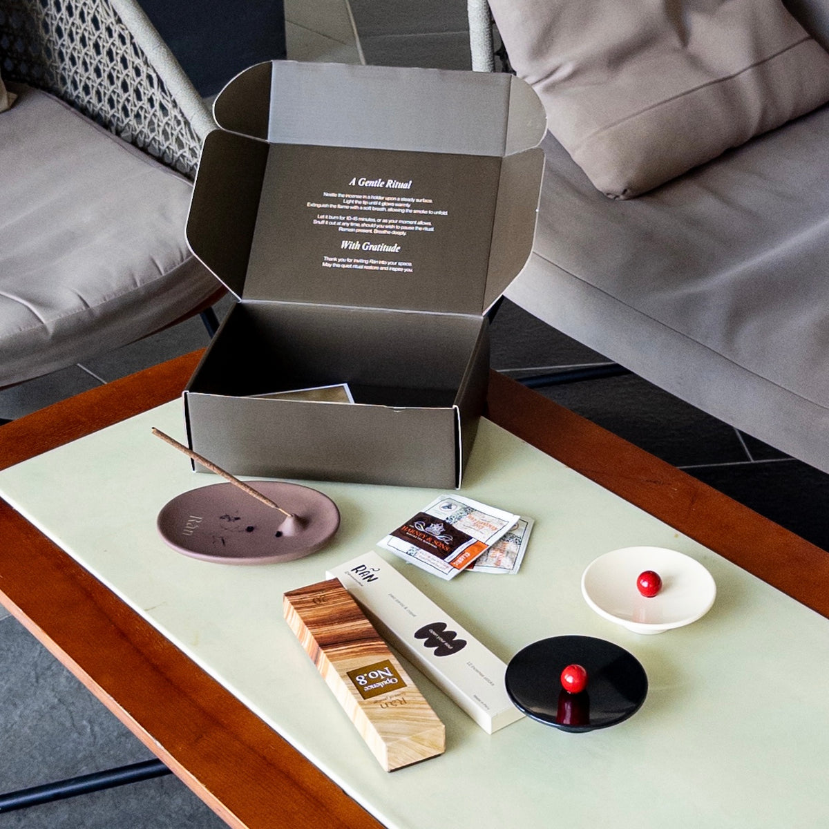 Rán incense gift box unboxed on a table with palo santo incense, holders and tea